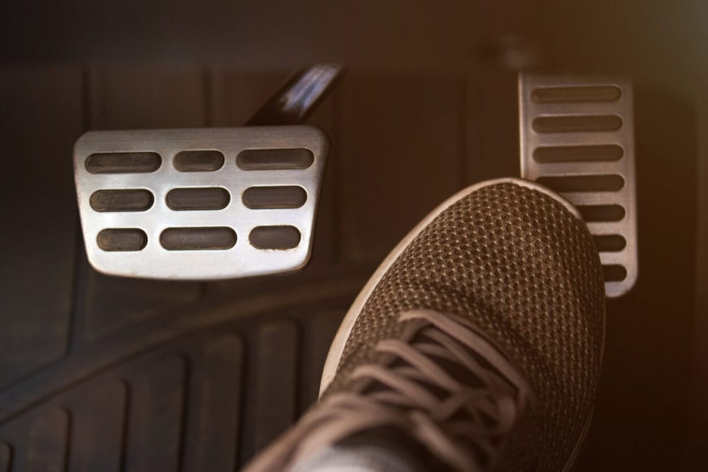 Foot on vehicle accelerator pedal