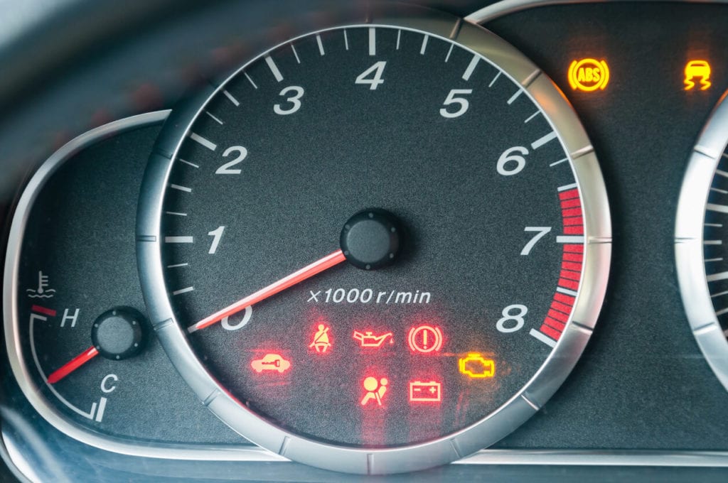 car dashboard with all warning lights illuminated 