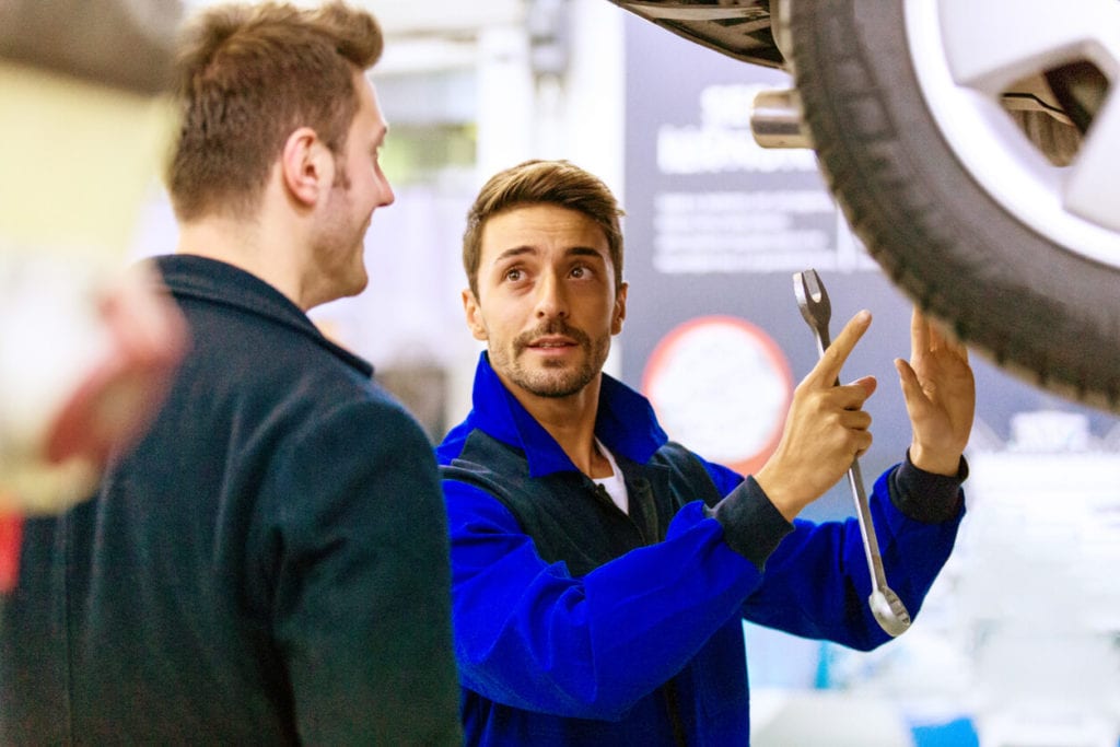 Mechanic talking to car owner