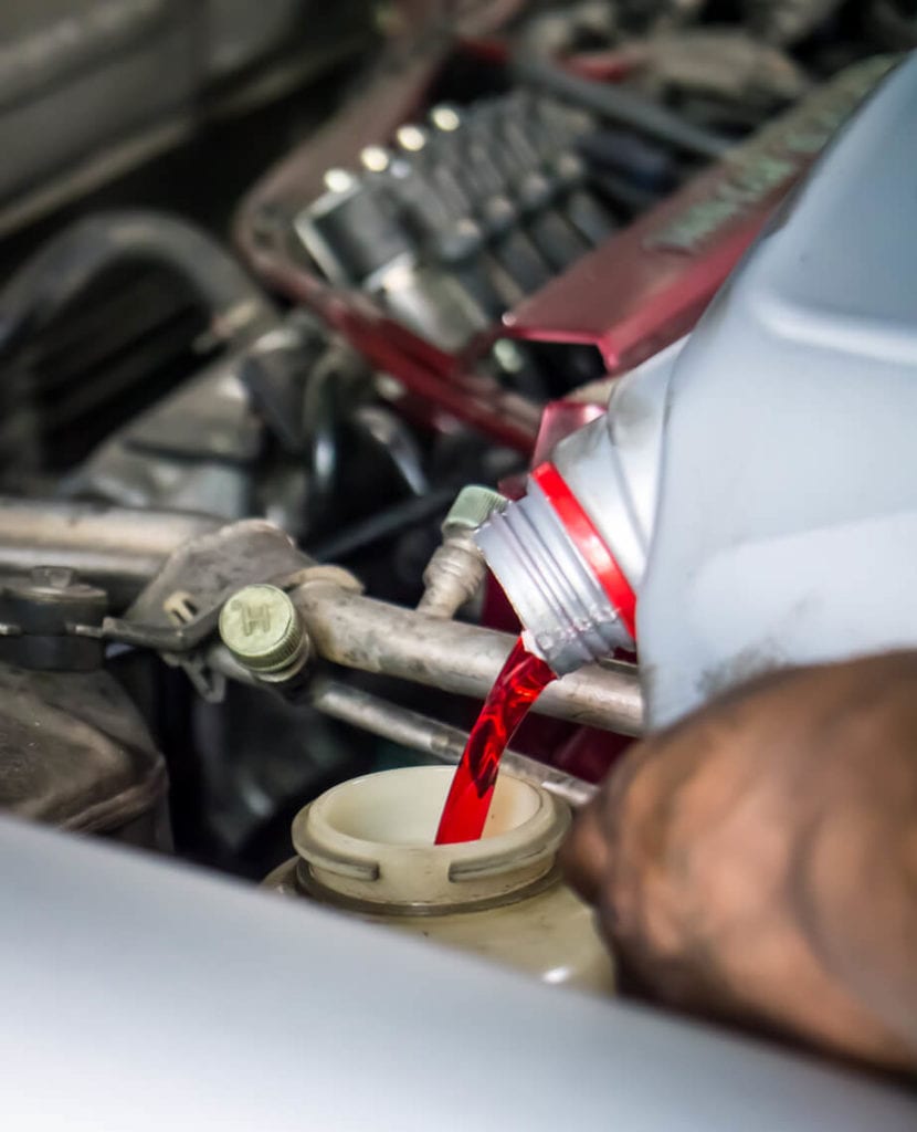 pouring transmission fluid into vehicle