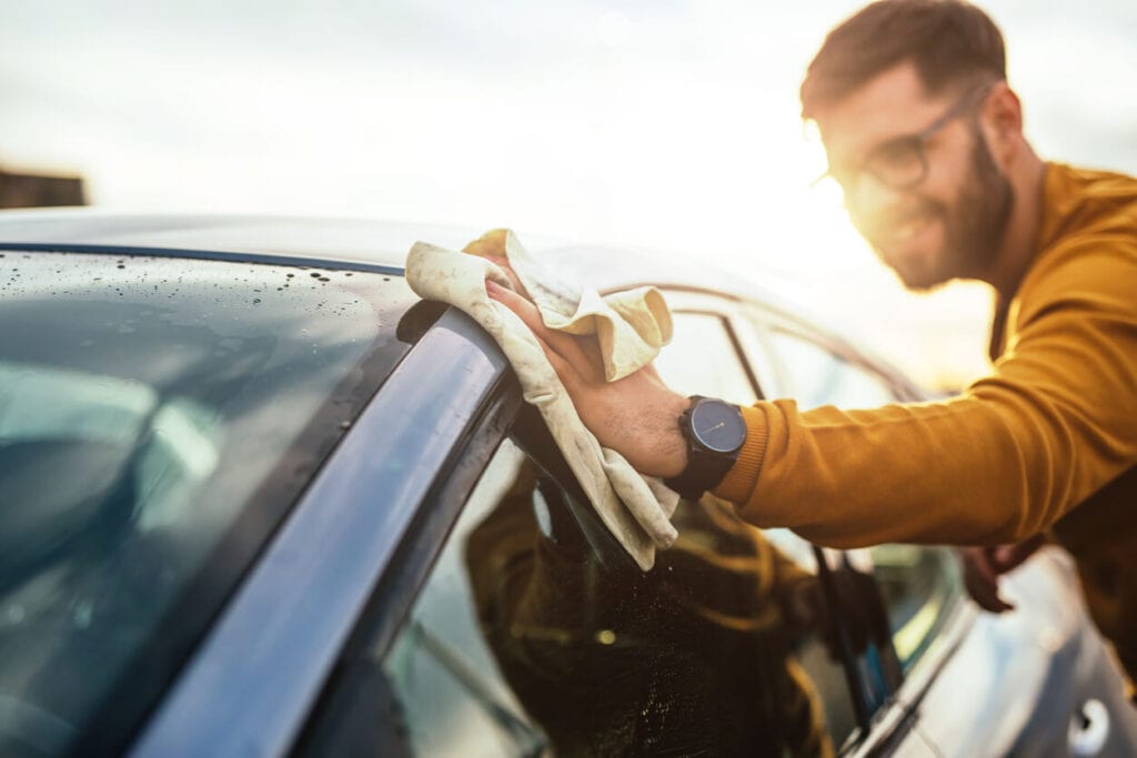 Man Washing Car At Home