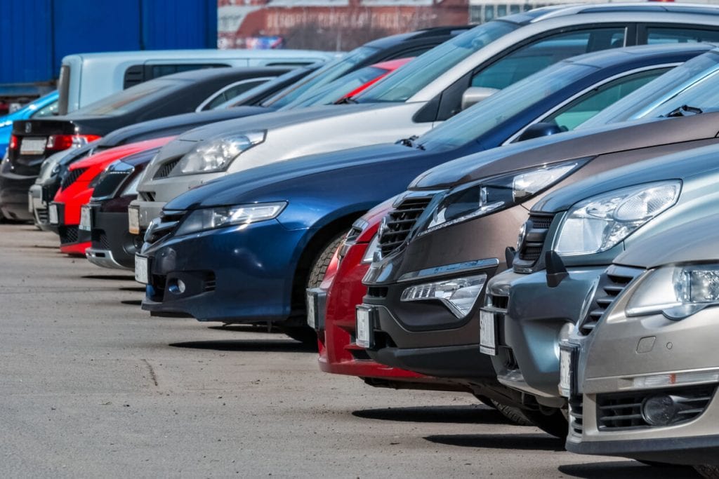 five automobiles of different colors and styles