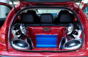 music big loudspeakers installed in a red car's trunk