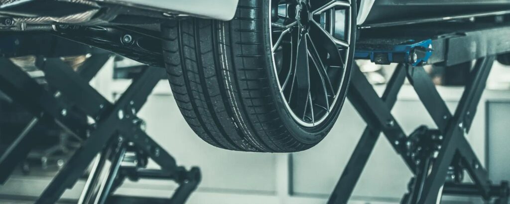 close-up of a car tire on a hydraulic lift